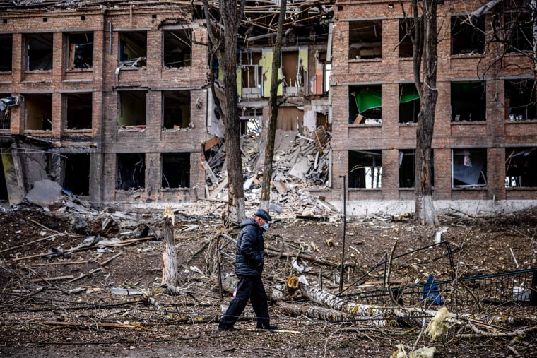A man walks in front of a destroyed building after a Russian missile attack in the town of  Vasylkiv, near Kyiv, on Feb. 27, 2022.