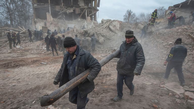 People remove debris at the site of a military base building that, according to the Ukrainian ground forces, was destroyed by an air strike, in the town of Okhtyrka in the Sumy region, Ukraine February 28, 2022. Irina Rybakova/Press service of the Ukrainian ground forces/Handout via REUTERS ATTENTION EDITORS - THIS IMAGE HAS BEEN SUPPLIED BY A THIRD PARTY.
