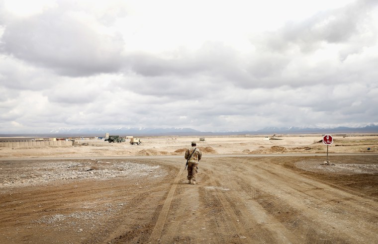 A soldier on a deserted stretch of road on Forward Operating Base Shank, near Pul-e Alam, Afghanistan in 2014.
